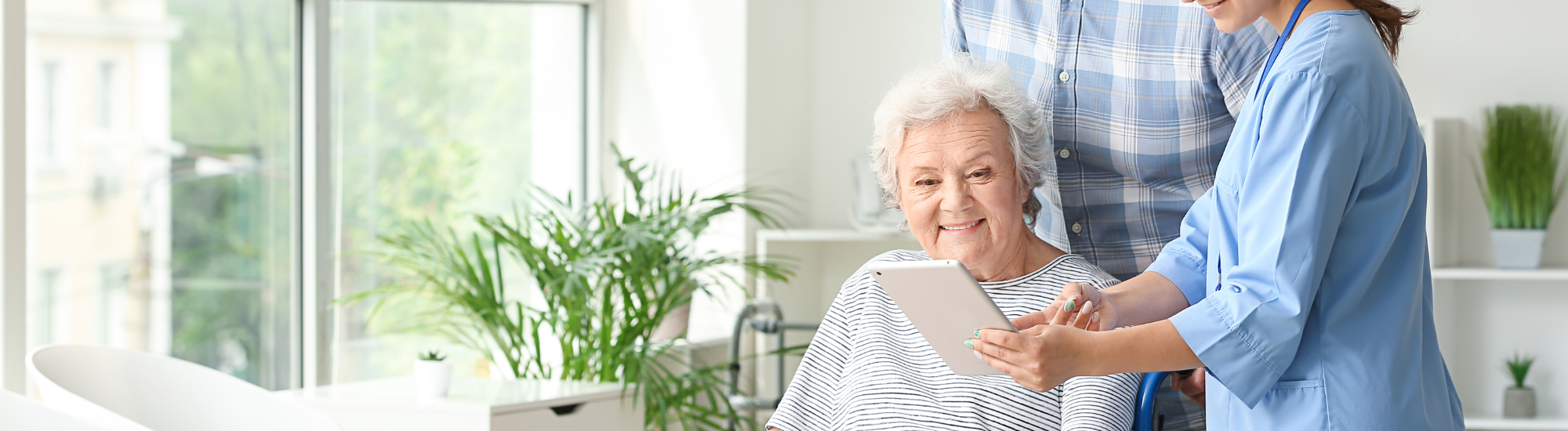 Nurse and elderly lady looking at a calendar together.